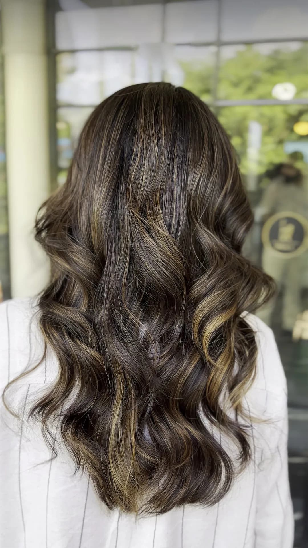 Brunette waves with fine blonde highlights