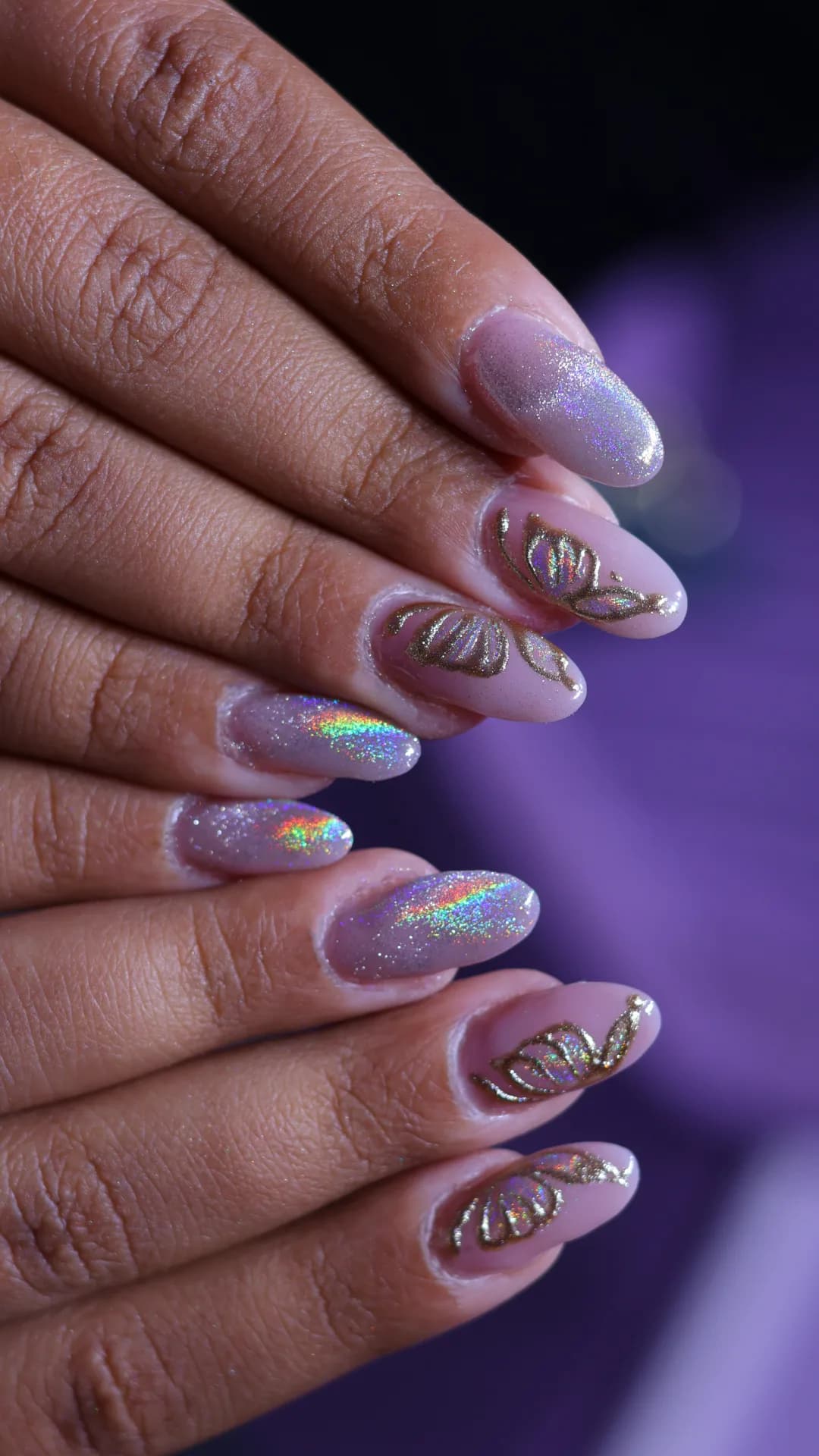 Chrome nails with gold butterfly-wing art